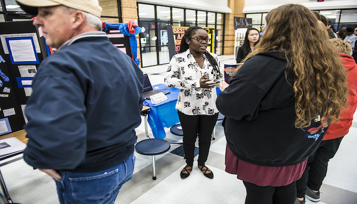 Blackman High School senior Brianna Davies explains her research project to visitors during the Feb. 8 Blackman Collegiate Academy Capstone Gallery Walk in the school’s cafeteria. MTSU is among Davies’ college choices. (MTSU photo by Eric Sutton)