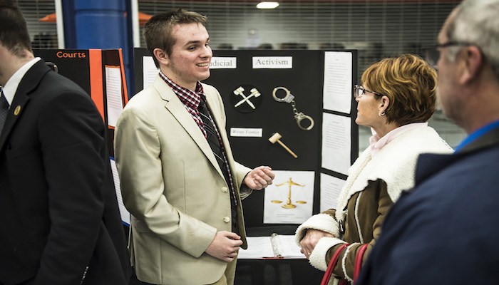 Blackman High School senior Ryan Foster explains his research project to visitors during the Feb. 8 Blackman Collegiate Academy Capstone Gallery Walk in the school’s cafeteria. Foster plans to attend MTSU and study business and marketing. (MTSU photo by Eric Sutton)