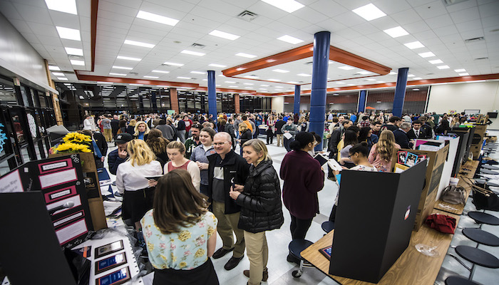 A large crowd makes the rounds of student research projects on display during the Feb. 8 Blackman Collegiate Academy Capstone Gallery Walk in the Blackman High School cafeteria. (MTSU photo by Eric Sutton)