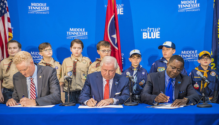 From right to left, MTSU President Sidney A. McPhee, MTSU Trustee J.B. Baker, and Larry Brown, CEO of the Middle Tennessee Council of the Boy Scouts of America, sign a partnership Wednesday, March 7, in the Strobel Lobby that connects the Davis Science Building and Wiser-Patten Science Hall at MTSU. Behind them are Cub Scouts from Scales and Rockvale elementary schools. The agreement allows the university to be a greater resource for scouting programs, particularly in science and technology. (MTSU photo by Eric B. Sutton)