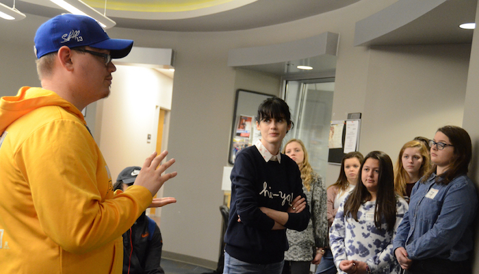 Rusty Ellis, left, a senior journalism major from Memphis, Tenn., tells Blackman Collegiate Academy students about all the potential opportunities young journalists might have if they consider being a part of Sidelines, the independent student newspaper at MTSU. Ellis is the sports editor.