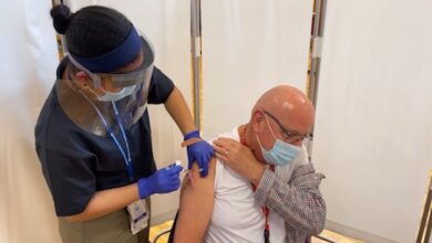 Dr. John Nadeau receiving the Moderna COVID-19 vaccine
