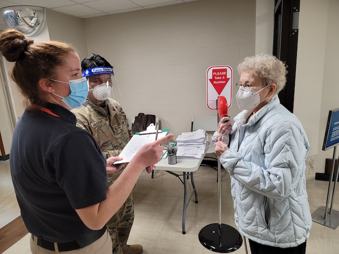 Army National Guard and TVHS employee assist Army Veteran at TVHS walk-in vaccine clinic
