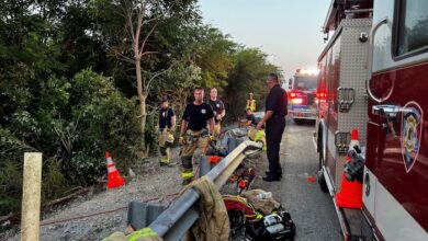 Driver trapped after semi plunges down steep embankment