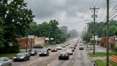 A four-lane suburban arterial road with no sidewalk on a humid Middle Tennessee afternoon