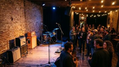 Interior of a small live music venue with a lit stage, amplifiers and a standing crowd (illustrative)