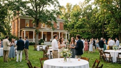 Evening garden party with white-linen tables and string lights on the lawn of a historic red-brick Southern home (illustrative)