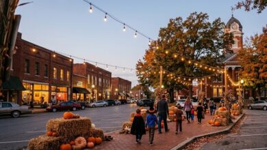 Families trick-or-treating past hay bales and string lights on a small-town Tennessee square (illustrative)