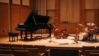 A recital hall stage set with a grand piano, upright bass, drums and saxophone (illustrative)